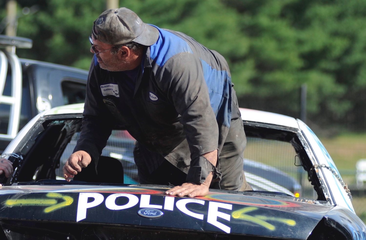 Exit lane. Michael Wiener, owner of Russell’s Garage in Loch Sheldrake, NY climbs out the rear window of his Ford Crown Victoria racecar, “Police.”